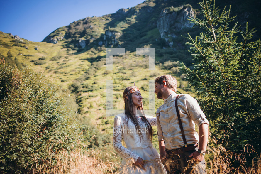 bride and groom against a mountain backdrop 