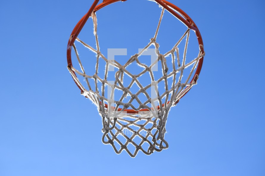 outdoor basketball hoop against blue sky 
