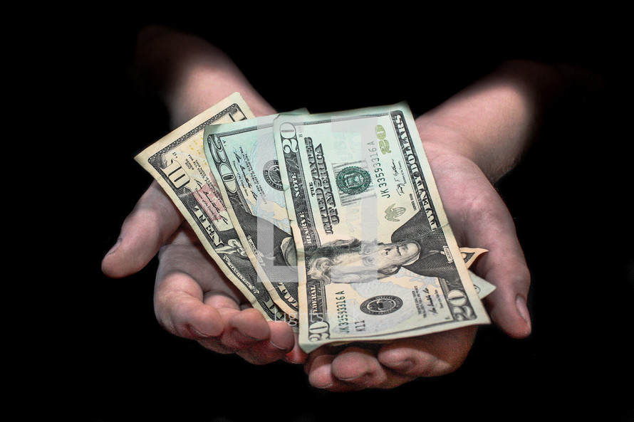 cupped hands holding cash 