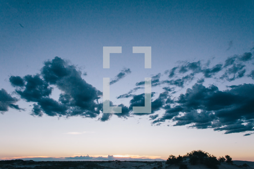 clouds above desert mountains 