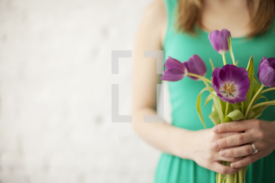 woman holding a bouquet of tulips 