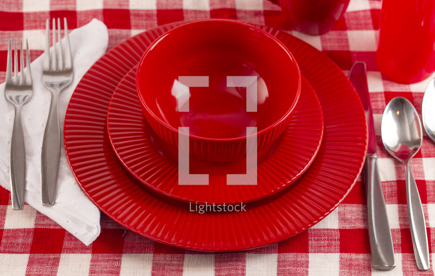 Red place setting on white background