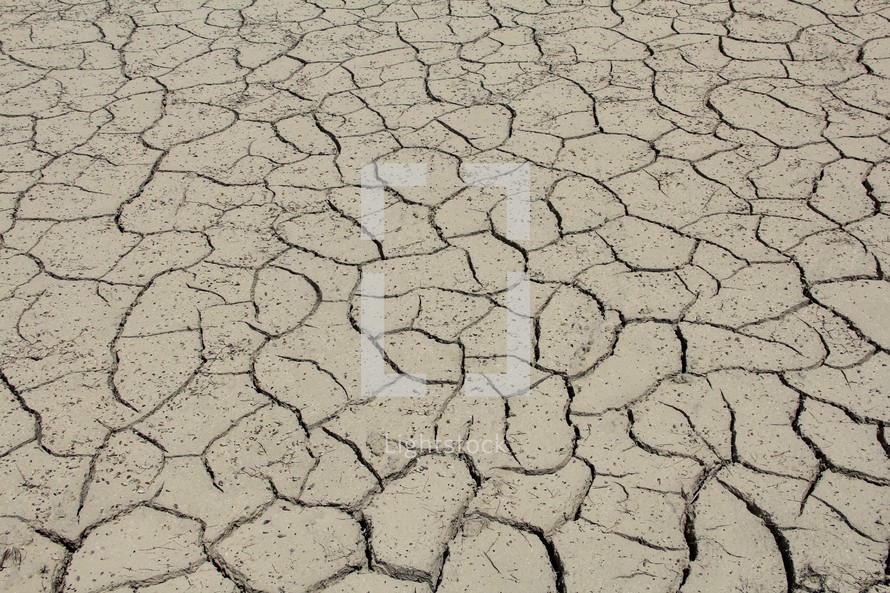 Parched clay soil in a dry lake bed during a drought 