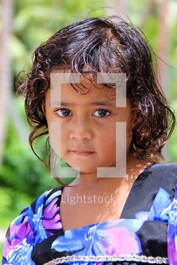 Face of a young Micronesian girl dressed to go to church