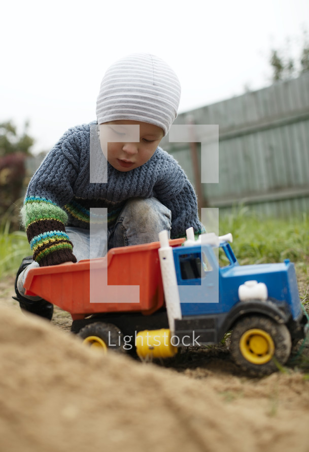 Boy playing with toy truck outdoor