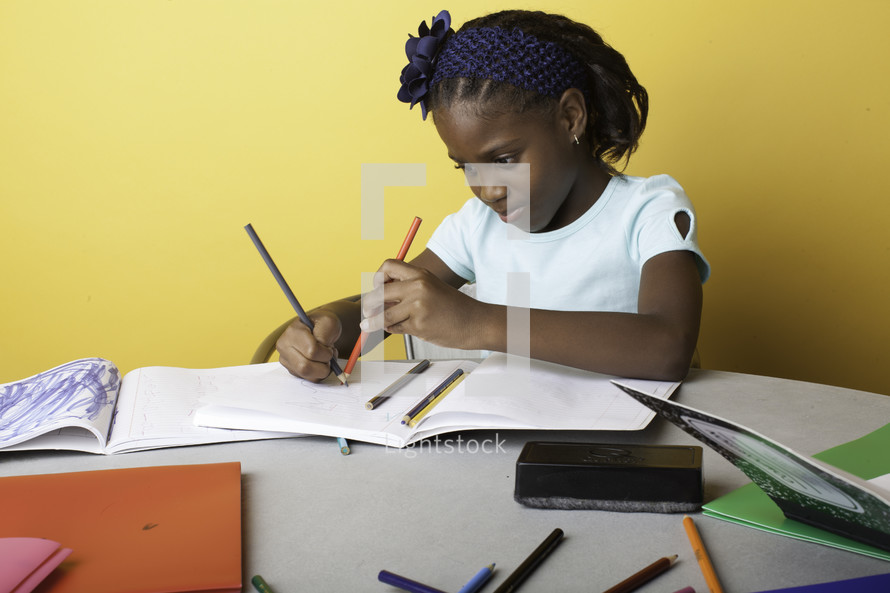 a girl child coloring on paper 