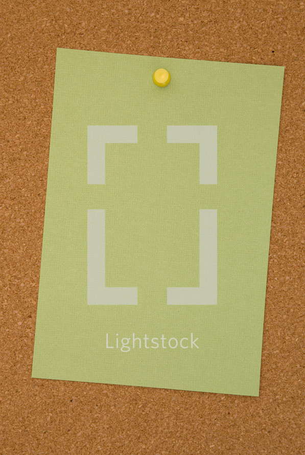 blank paper pinned to a cork board 