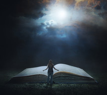 woman standing in front of a Giant Bible 