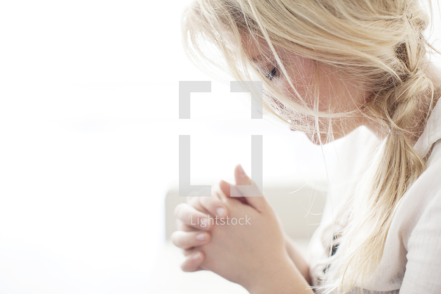 woman with head bowed in prayer