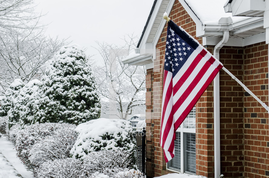 American flag on a house in the winter 