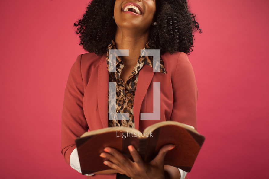 smiling woman reading a Bible 