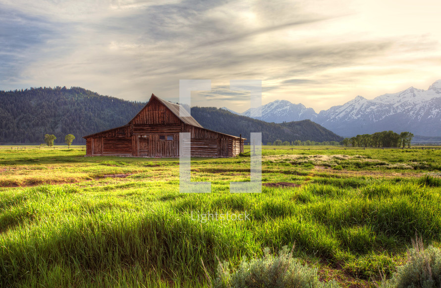 barn and snow capped mountains 