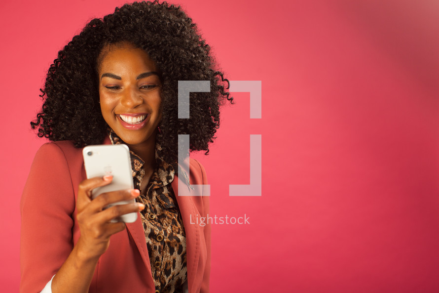 businesswoman looking at a cellphone screen 