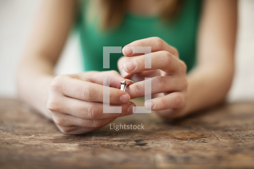Woman playing with a wedding ring on her finger. 