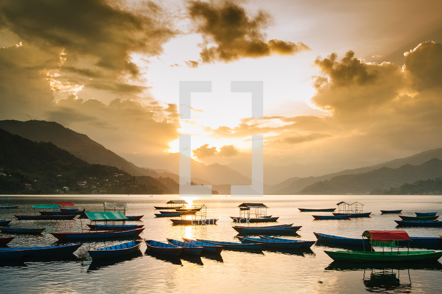 boats in a bay at sunrise in Pokhara 