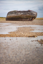 beached boat on sand 