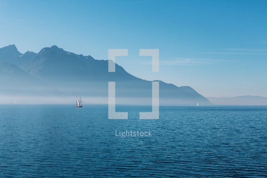 view of a sailboat from the coast of Switzerland 