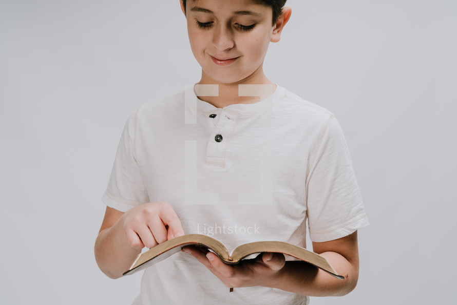 boy reading a Bible 