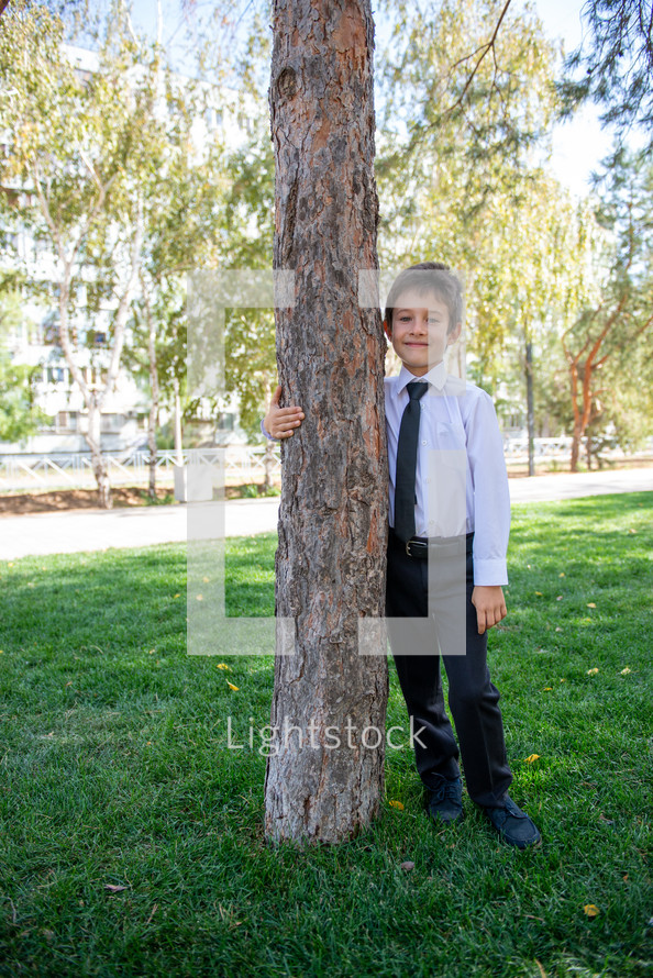 portrait of a boy in dress clothes outdoors 