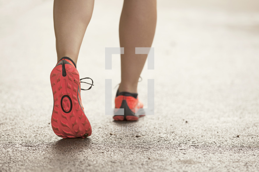 Close up of woman's running shoes as she walks.