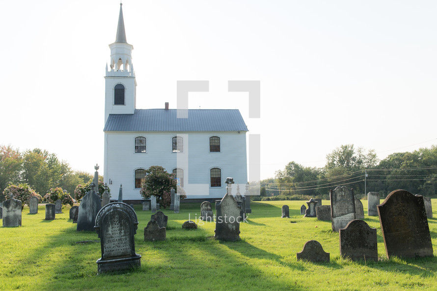 small rural white church with steeple 
