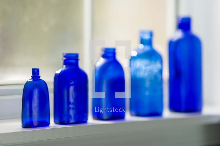 row of blue glass bottles 