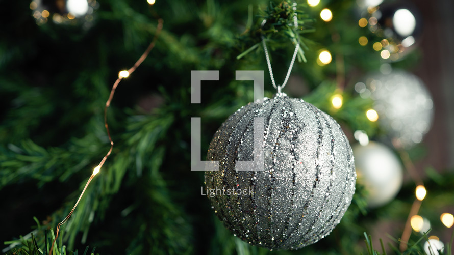silver ball as decoration on a Christmas tree