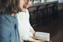 Two men reading discussing the Bible at a Bible study