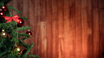Christmas tree with wooden wall in the background 