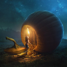 A young girl tries to go inside a very large pumpkin.