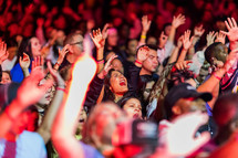 people singing with raised hands at a Christian Concert 