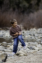 little boy laughing outdoors