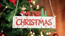 Merry Christmas sign with tree on the background