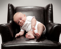 infant boy in a leather chair 
