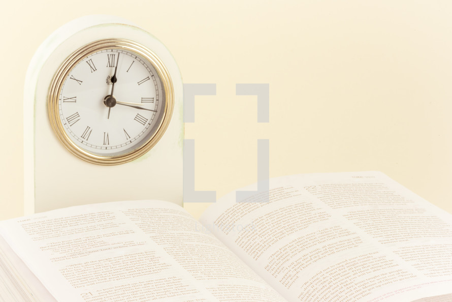 clock and open Bible 