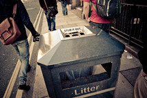 trashcan on a city sidewalk 