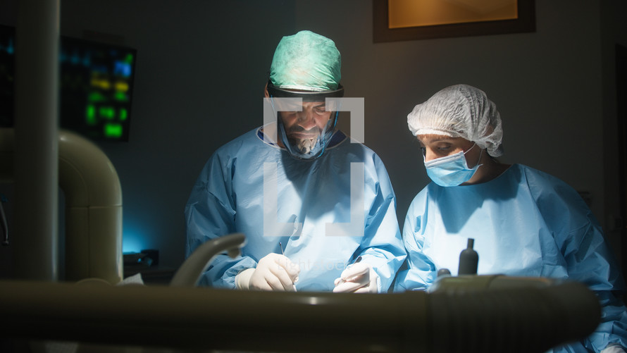 Doctor and assistant works in operating room