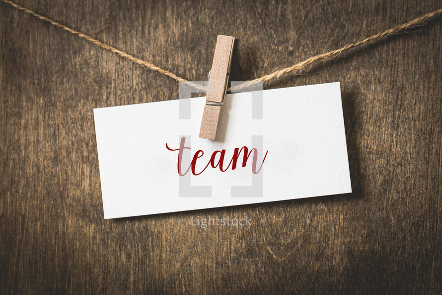 word team on white card stock hanging from a clothespin on a clothesline 