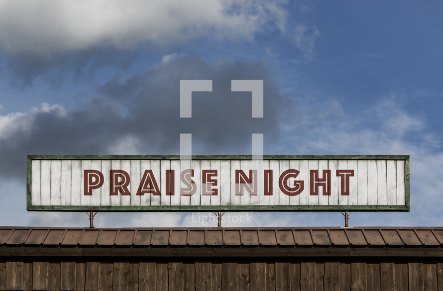 Praise night sign on the roof of a building 