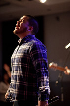man singing at a worship service 