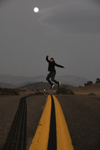 a man jumping in the middle of a road 