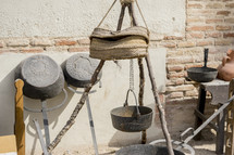 metal pot hanging over a fire 