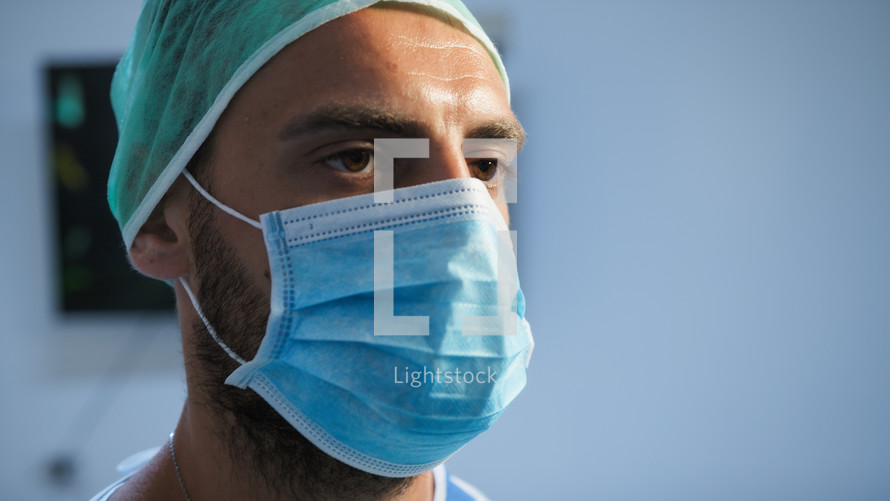 Italian Dentist wears mask before surgery
