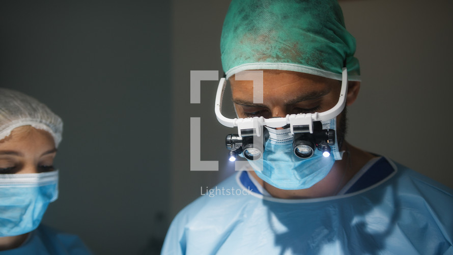Doctor With Surgical headlamp into operating room