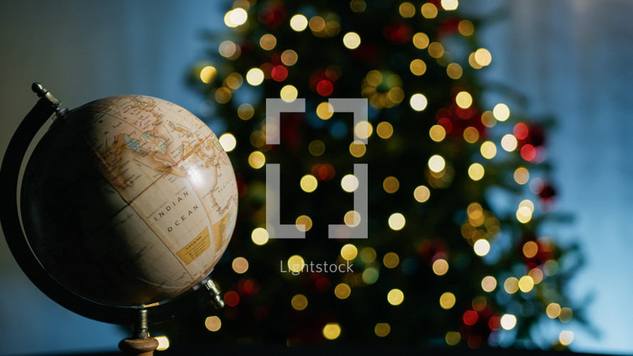 Earth rotating under Christmas tree lights background 