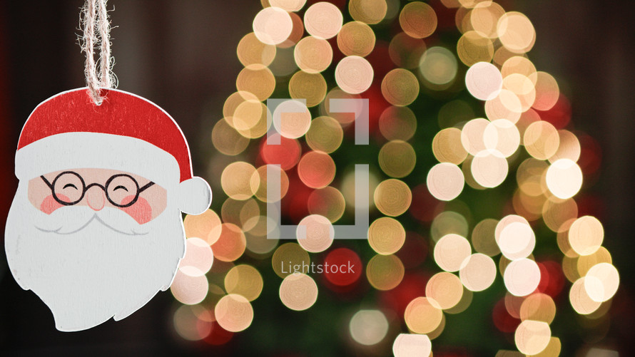Santa Claus Hanging on blurred Christmas tree