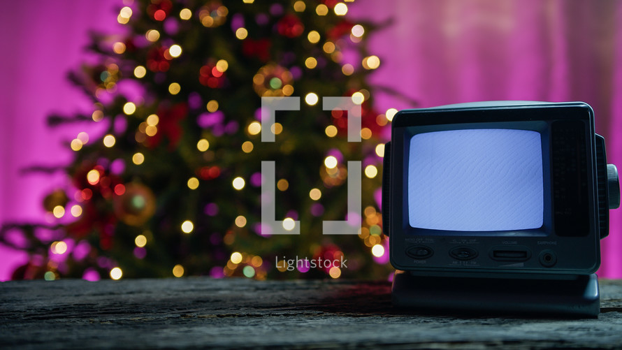 Old static tv with Christmas background 