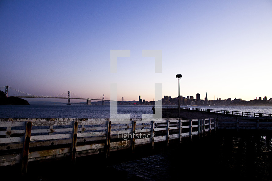 city dock looking at ocean San Francisco Bay bridge sunset
