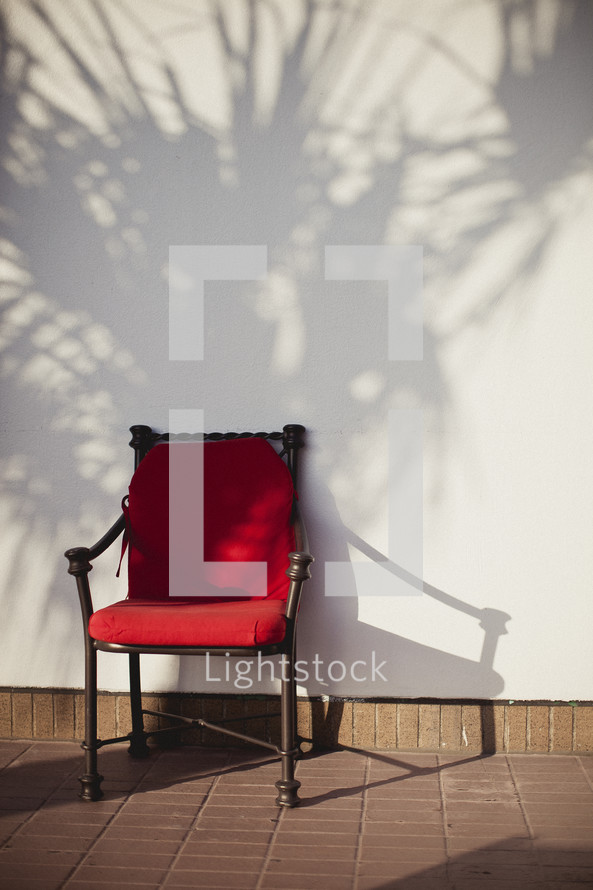 A red chair against a wall