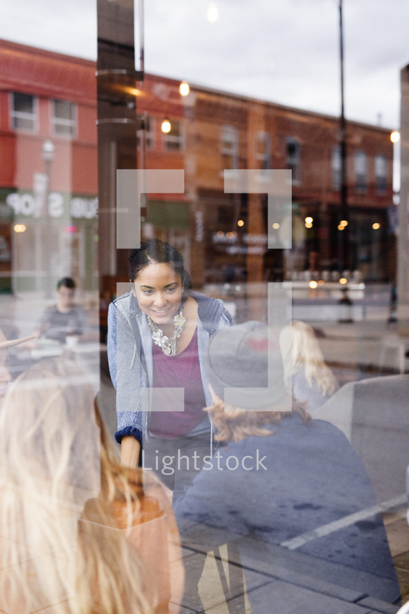 Young adults in a coffee shop window 